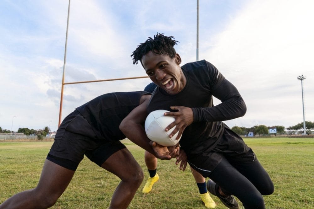 male-athletes-playing-rugby-field